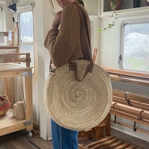 Moroccan woven round basket bag, leather straps.